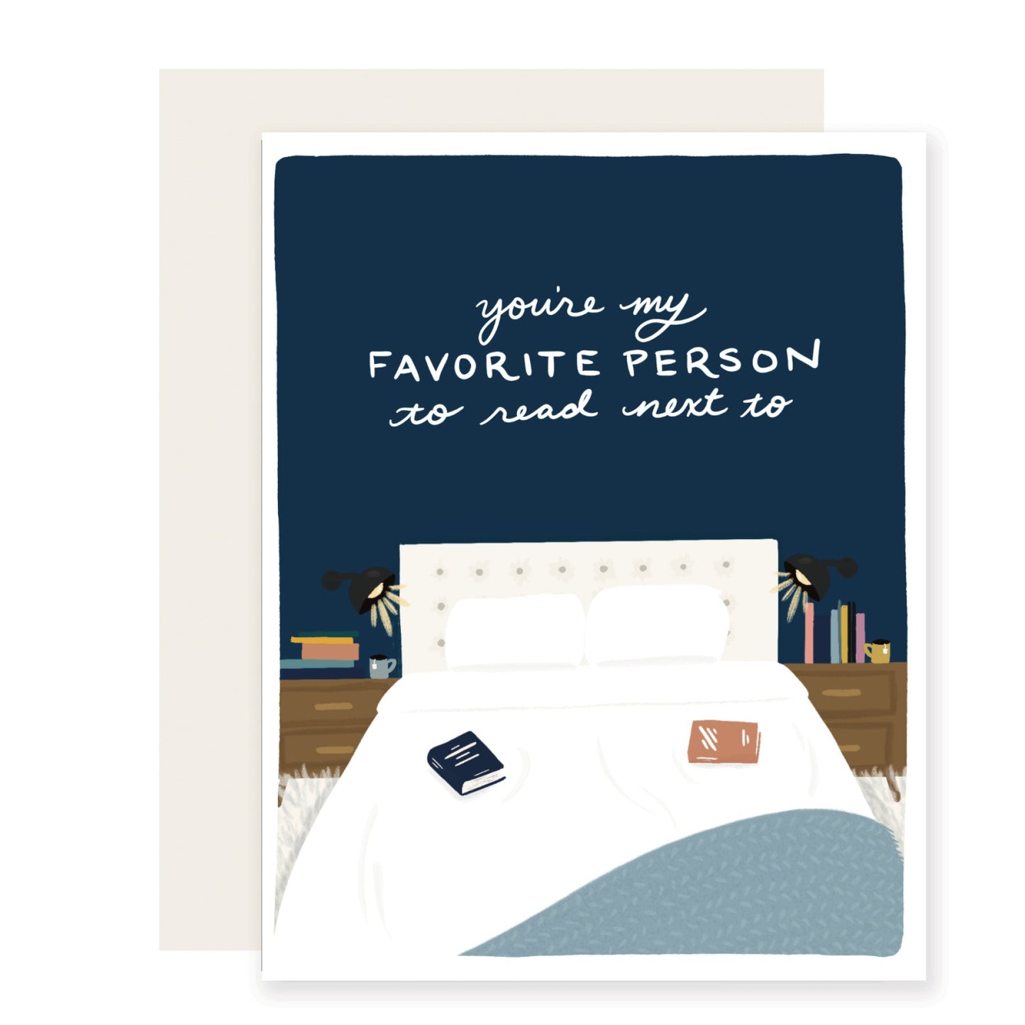 A heartwarming love card with a charming illustration of a cozy bed, complete with bedside lamps and books on each side. The card reads 'You're my favorite person to read next to,' evoking feelings of warmth and affection.