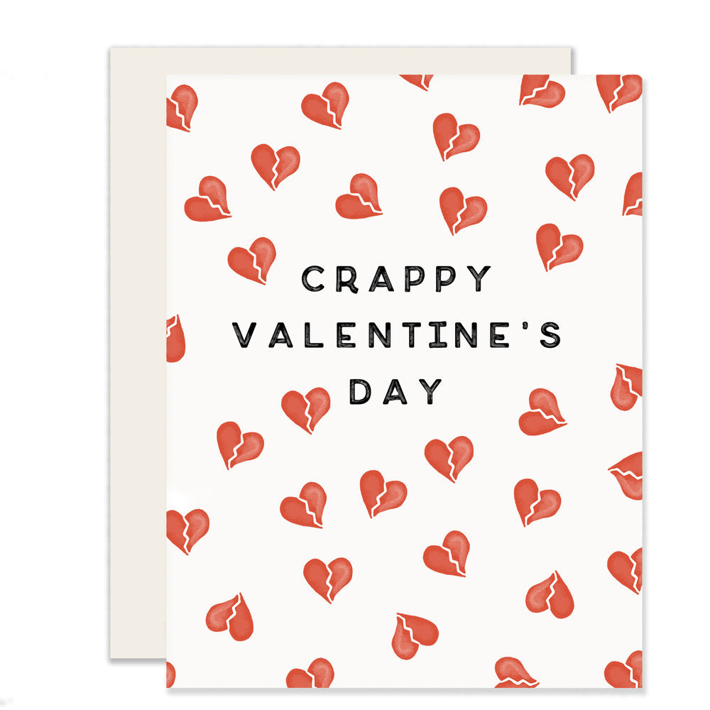 Humorous Valentine's Day card with the words 'Crappy Valentine's Day' and delicately illustrated broken hearts on the front, adding a touch of playful sarcasm to the occasion.