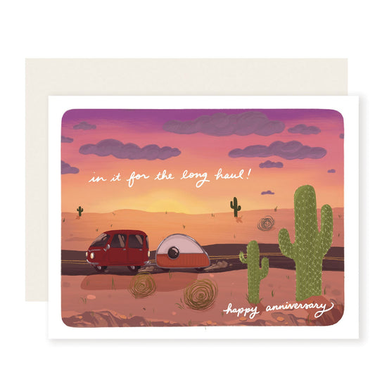 A fun anniversary card with a cute van pulling a tiny camper on a desert road under an ombre sky, reading 'In it for the long haul. Happy anniversary.