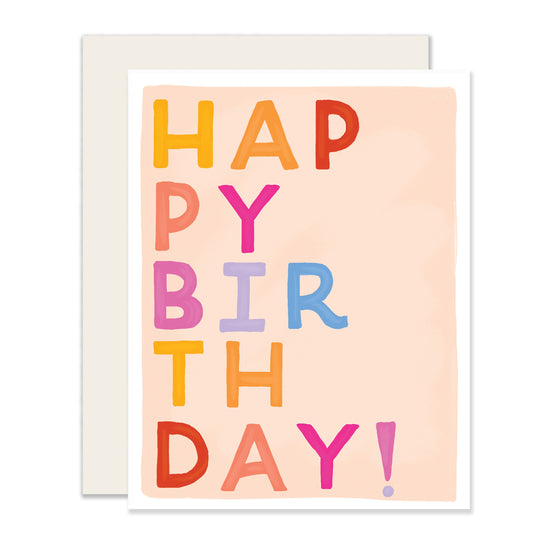 A simple yet colorful birthday card in a light pinkish-salmon hue. It features bold block letters spelling out 'Happy Birthday' in a vibrant, eye-catching style. The design is bright and cheery, perfect for sending joyful birthday wishes.