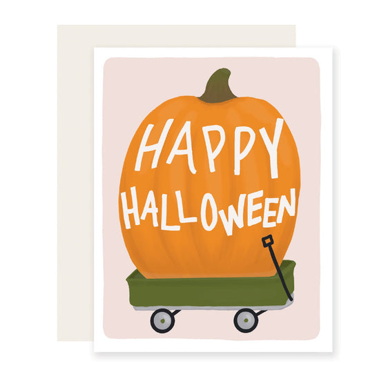 An adorable Halloween card featuring a very large illustrated pumpkin in a green wagon, accompanied by the text 'Happy Halloween'.