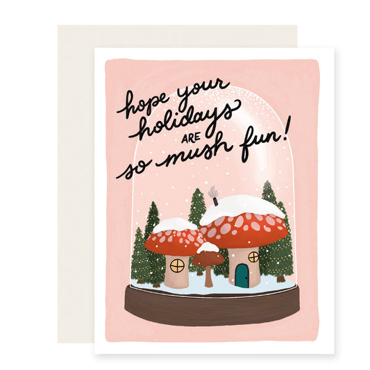 A charmingly illustrated Christmas card featuring a mushroom snow globe illustration with the text 'Hope your holidays are so mush-fun'.