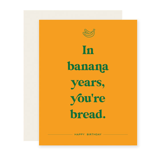 Yellow card featuring green text with a humorous birthday message: 'In banana years, you're bread. Happy Birthday!'