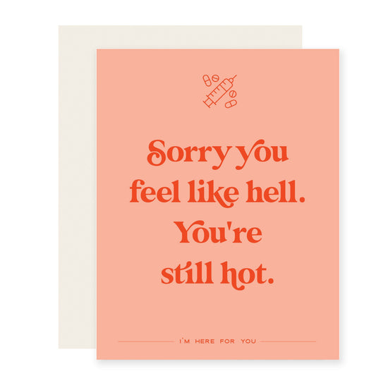 Salmon colored  card featuring red-orange text with a humorous yet supportive message: "Sorry you feel like hell. You're still hot. I'm here for you."