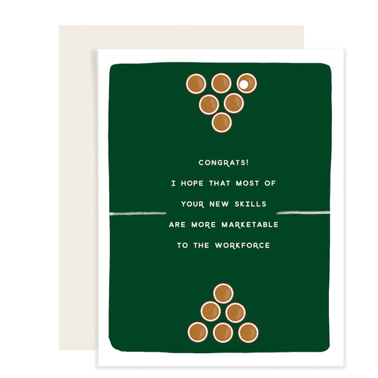 A graduation card featuring a simple illustration of a ping pong table top, with beer cups set in classic beer pong formation on each side. The card humorously reads 'Congrats. I hope that most of your new skills are more marketable to the workforce,' playfully referencing the popular college game while congratulating on graduation.