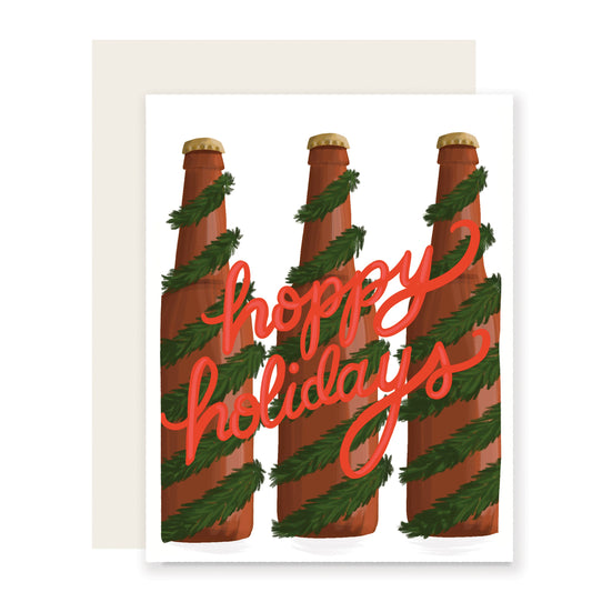An artfully illustrated holiday card with the playful message 'Hoppy Holidays.' The card showcases beer bottles wrapped in festive holiday garland, designed to uplift holiday spirits and bring joy, making it an ideal choice for beer enthusiasts. 🍻🎄🎁